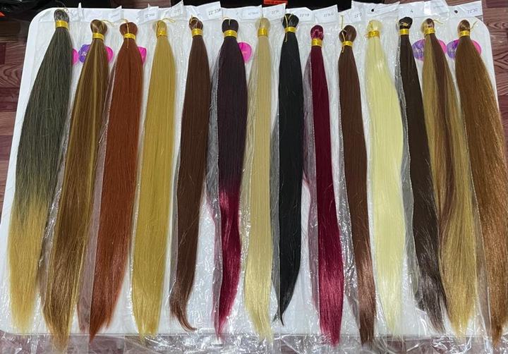 Bone straight braiding extensions laid out in a range of colours
